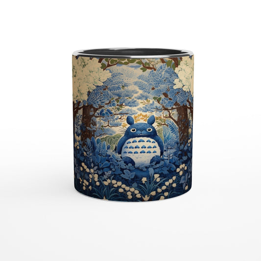 A cylindrical mug displays a Studio Ghibli Totoro character sitting within a blue and gold chinoiserie-style cherry blossom forest scene.