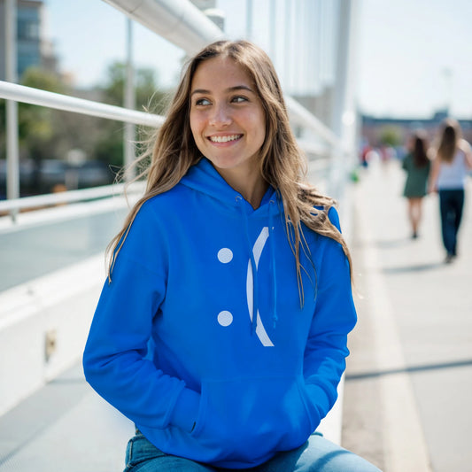 A person wearing a blue hoodie with a stylized white "Blue Screen of Death" error face design sits on a bridge outdoors.