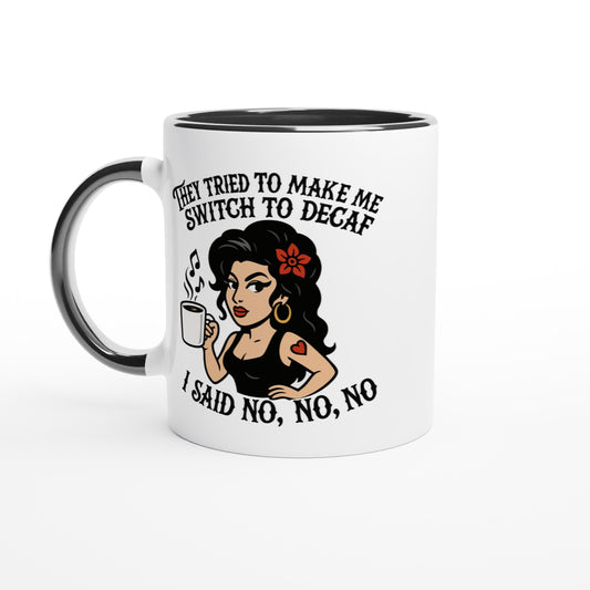 A black coffee mug displays a cartoon illustration of a woman holding a cup of coffee and text reading "They tried to make me switch to decaf," and "I said no, no, no.