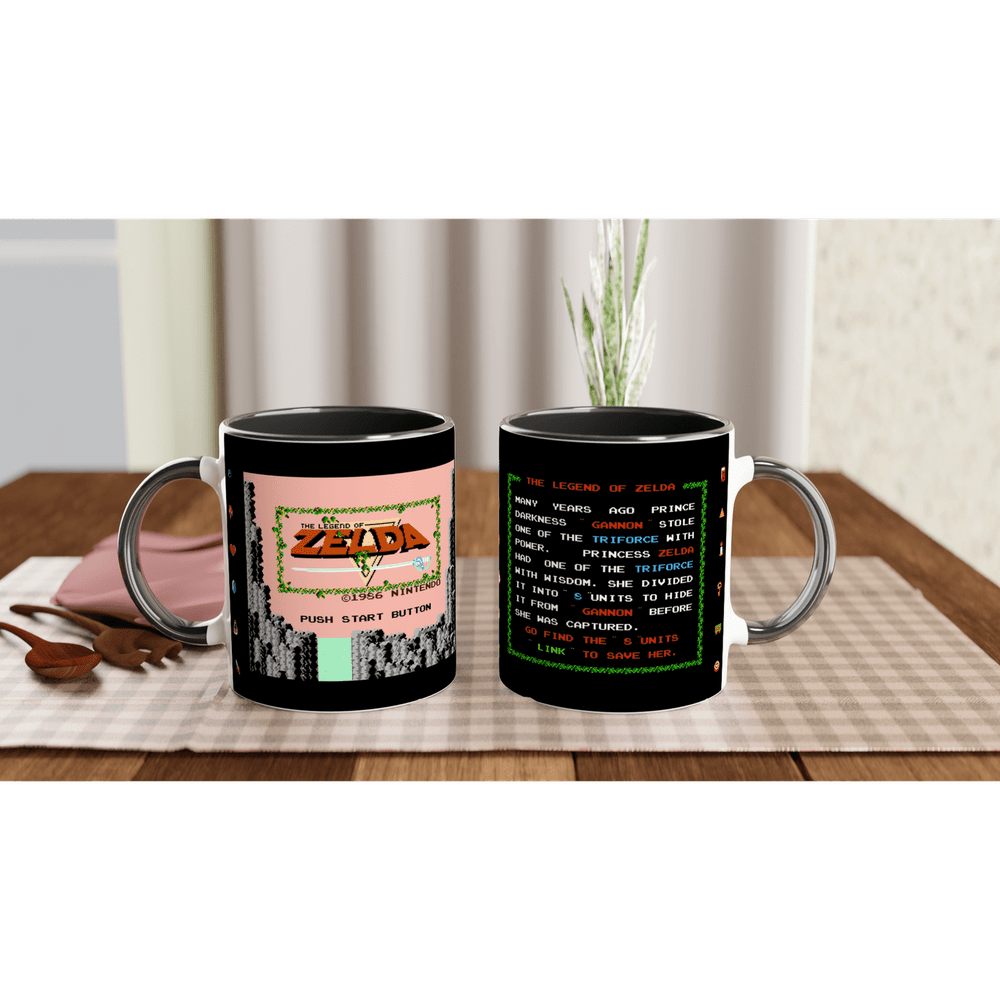 A black mug displays a design referencing The Legend of Zelda NES title screen on one side and vintage game text on the other.