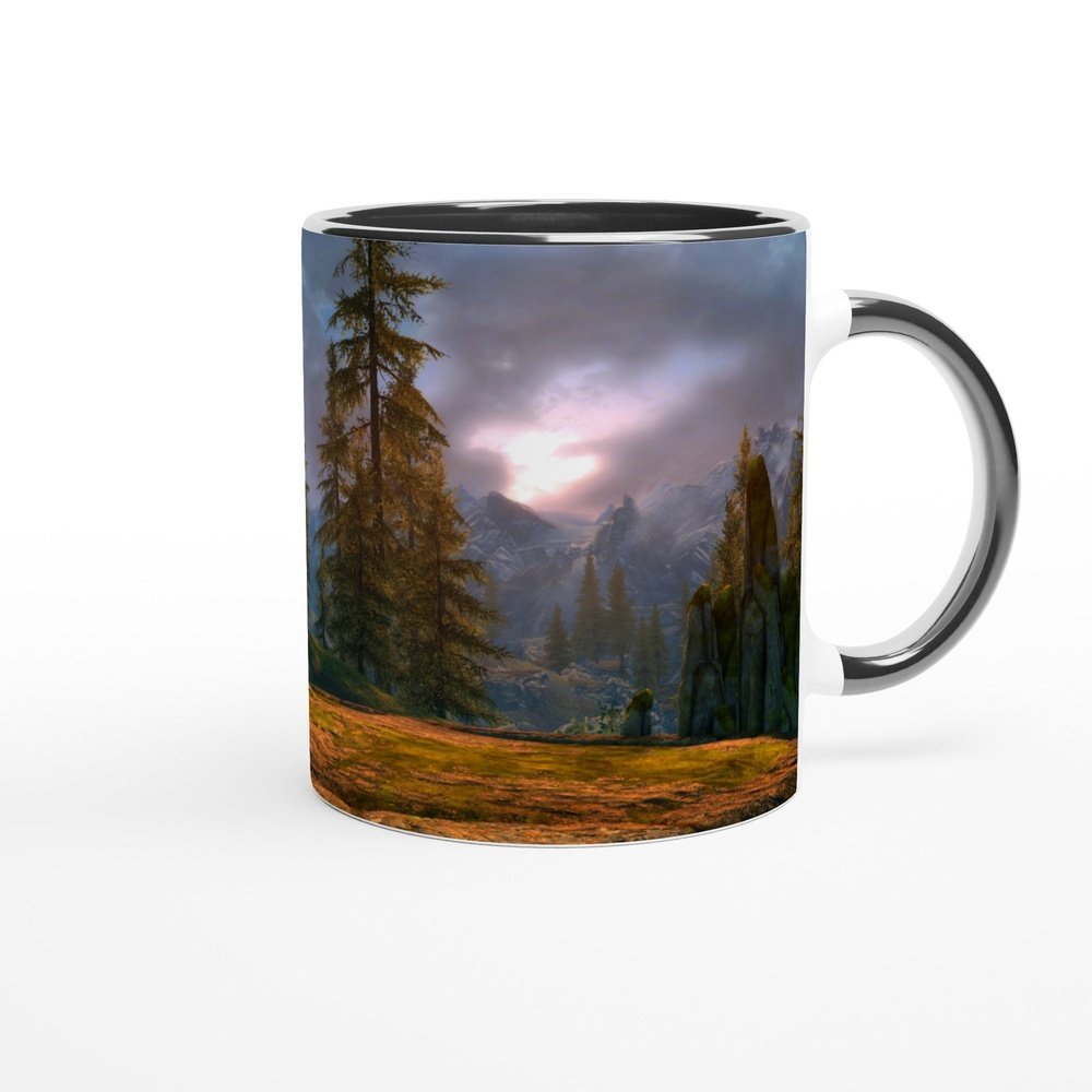 This 11oz Skyrim coffee mug features a landscape scene from The Elder Scrolls video game, depicting mountains and trees under a cloudy sky.