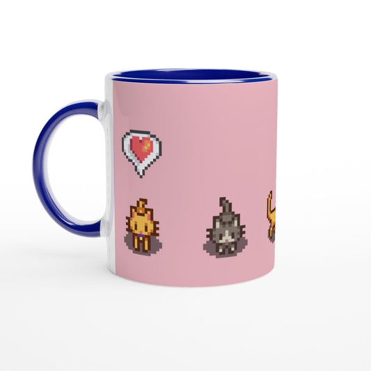 A white mug with a blue handle features pixel art of Ginger and Tabby cats and emotes from Stardew Valley on a pink background.