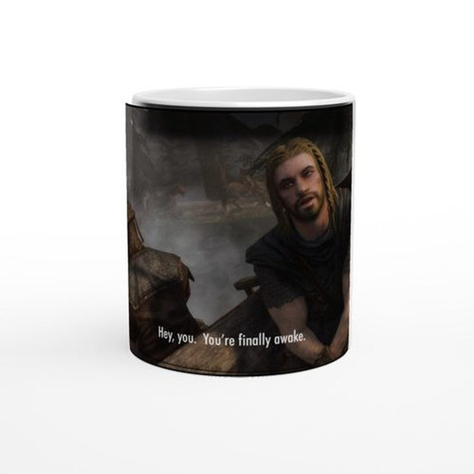 This white mug features a heat-changing design depicting characters from Skyrim with the phrase "Hey, you. You're finally awake.