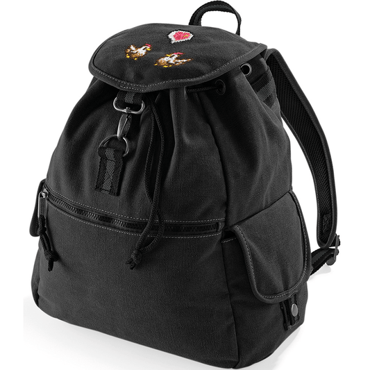 A black canvas backpack features embroidered chickens and a heart emote design inspired by the Stardew Valley video game.