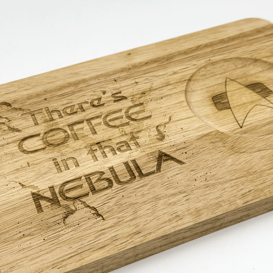 A wooden Voyager breakfast board features laser-engraved text reading "There's Coffee in that Nebula" and a Star Trek Delta Shield emblem.