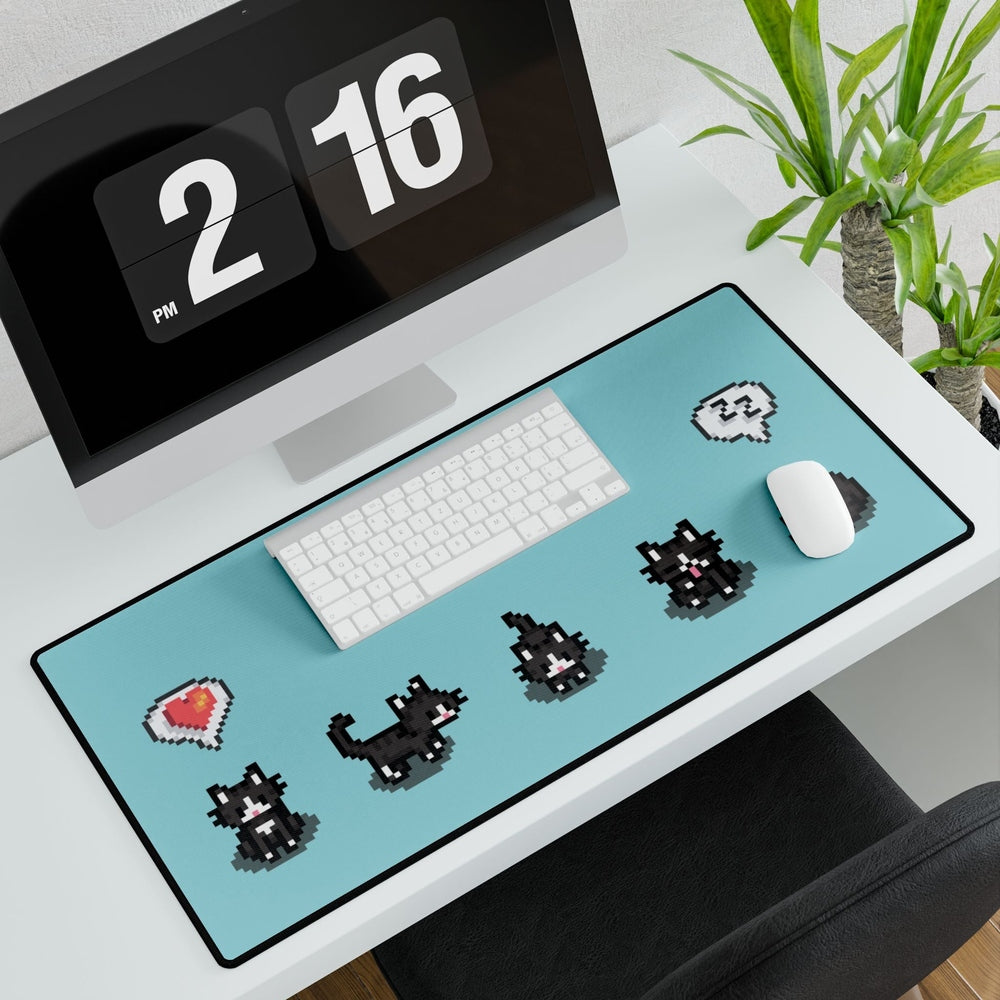 An extra large desk mat features a black and white pixelated pattern of tuxedo cats inspired by the computer game Stardew Valley.