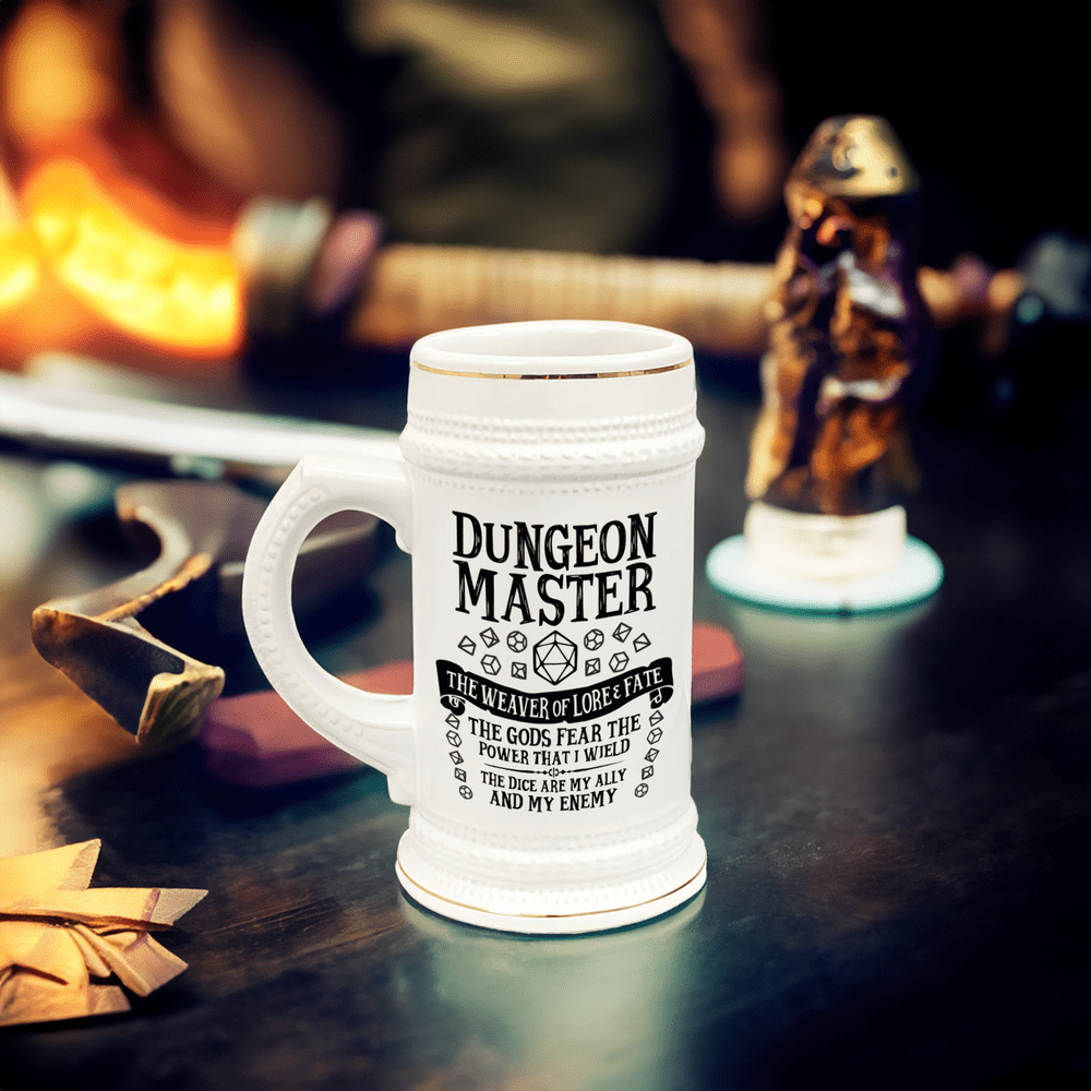 A white ceramic Dungeon Master tankard, resembling a DnD beer stein, sits on a wooden surface surrounded by fantasy-themed decorations.