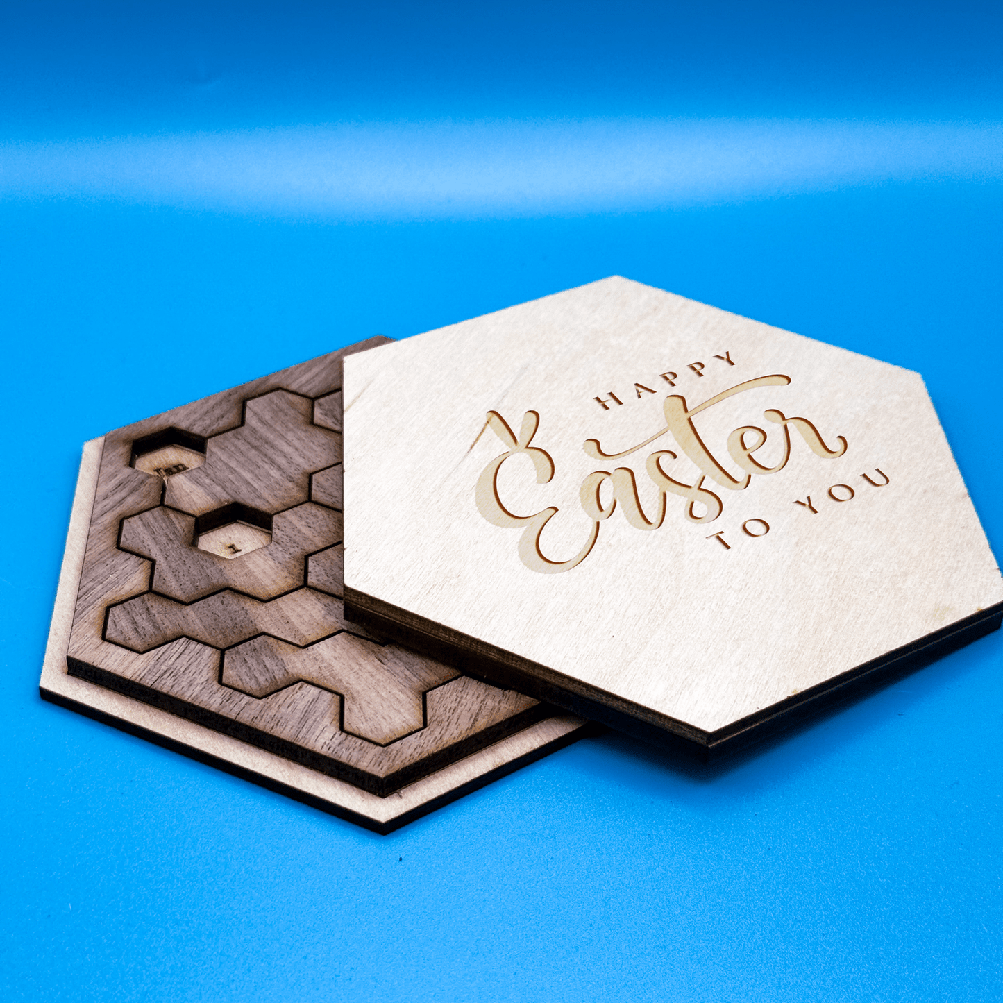 Two hexagon tiles form a Hexagon Calendar Puzzle, one displaying "Happy Easter to You" and the other featuring interlocking geometric shapes.