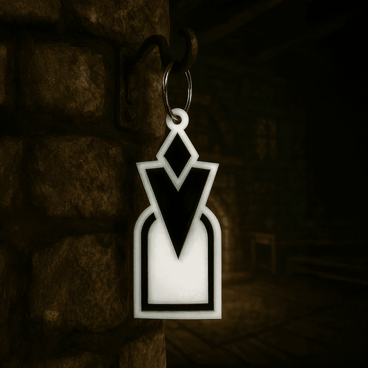 A 3D acrylic keyring featuring a black and white Skyrim inspired quest marker icon hanging from a metal ring on a stone wall.