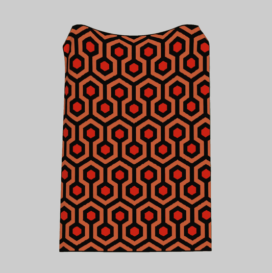 Patterned fabric with red and black hexagonal design on a green background