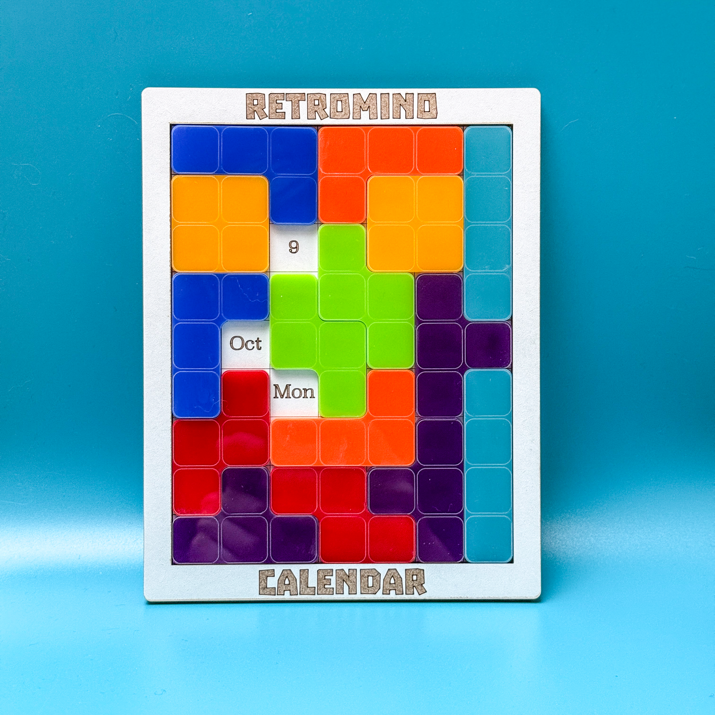 Tetris inspired colourful perpetual calendar with a retro design on a blue background