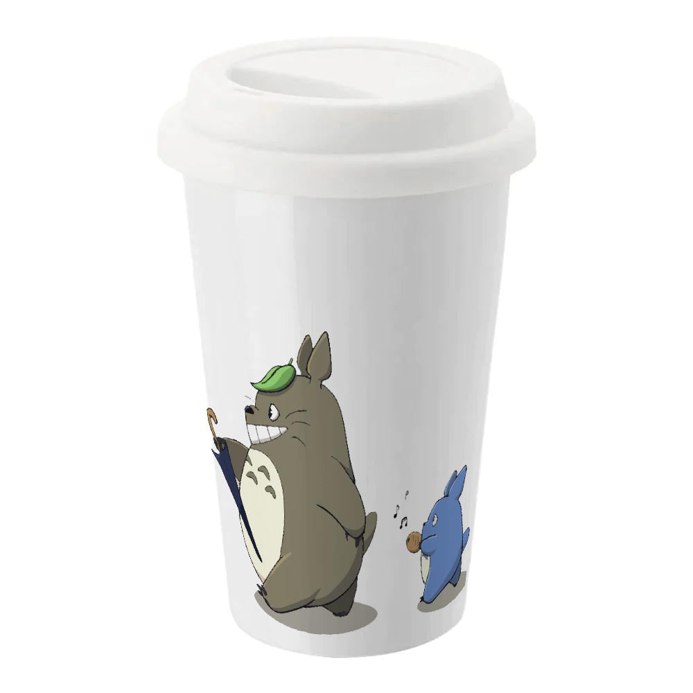 A white ceramic travel mug featuring Totoro from Studio Ghibli's anime alongside a smaller blue character and secured with a silicone lid.