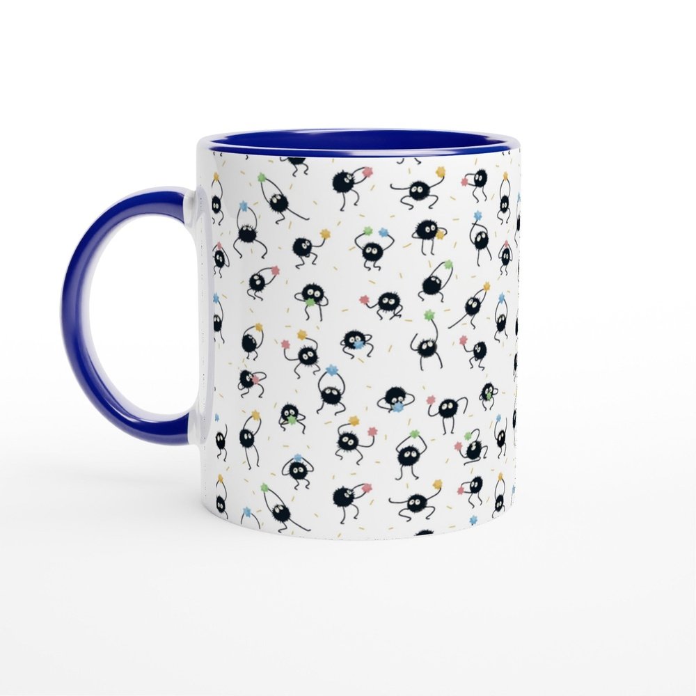 A white ceramic mug features a pattern of black soot sprites, also known as Susuwatari, inspired by Studio Ghibli's Spirited Away.