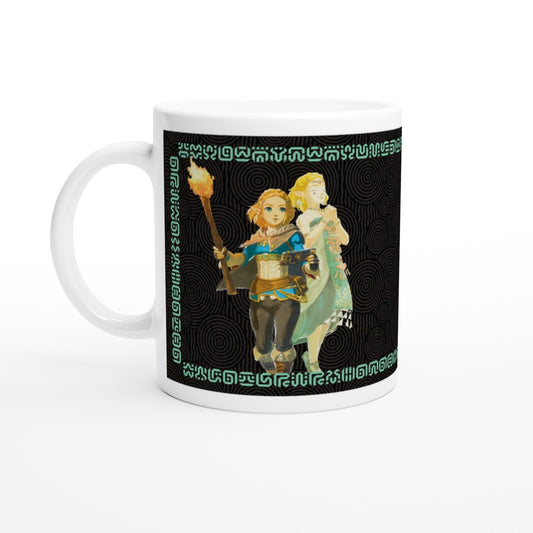 A white mug displays an illustration of Link and Zelda from The Legend of Zelda: Tears of the Kingdom, surrounded by Sheikah script patterns.