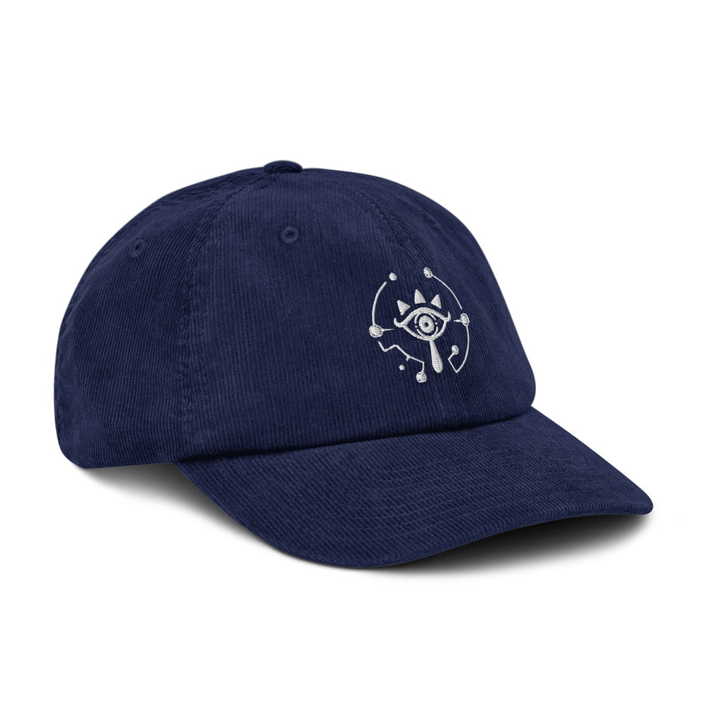 A navy blue Zelda Sheikah embroidered dad hat features a stylized eye design on the front panel.