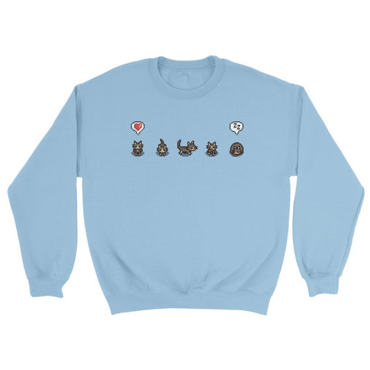 A light blue Stardew Valley jumper displays pixelated graphics of cats and emotes across the chest.