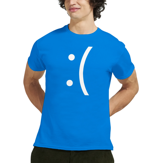 A man wears a blue Gildan 5000 t-shirt displaying a white sad face emoticon referencing the Blue Screen of Death error.