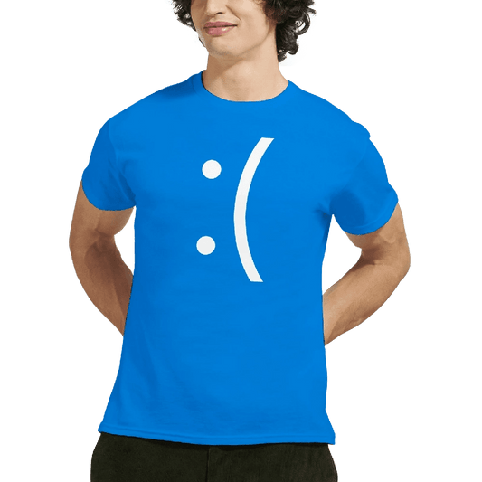 A man wears a blue Gildan 5000 t-shirt displaying a white sad face emoticon referencing the Blue Screen of Death error.