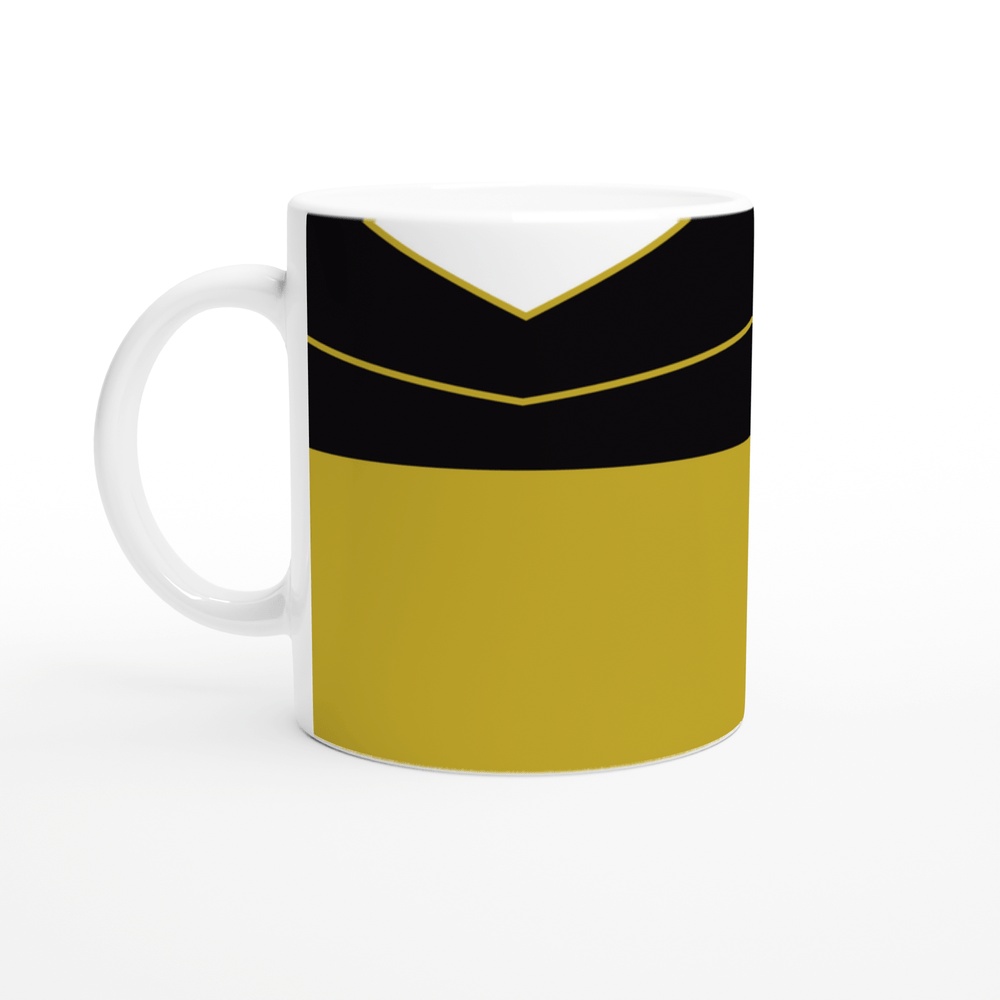 A white mug displays a design inspired by Star Trek TNG uniforms featuring gold, black, and white panels.