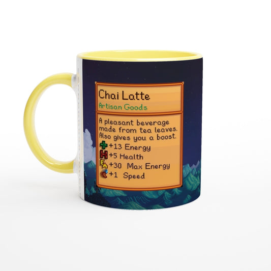 A Stardew Valley mug displays a yellow handle and green rim, featuring an illustration of a Chai Latte recipe card with details about its effects.
