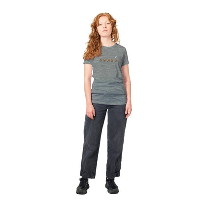 A person wearing a grey Stardew Valley T-shirt featuring emotes across the chest stands against a white background.