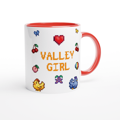 A white coffee mug features pixel art graphics including chickens, cherries, a prismatic Stardrop, and the words "Valley Girl" referencing the video game Stardew Valley.
