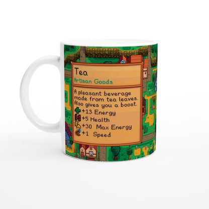 A white Stardew custom tea mug displays a pixelated graphic of an artisan goods description for tea, featuring stats and a background image from the game.