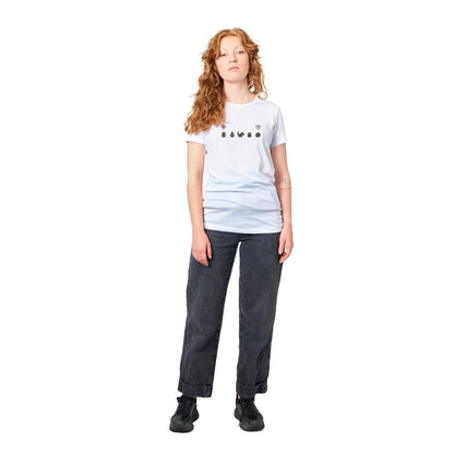 A person wearing a grey Stardew Valley T-shirt featuring black emotes across the chest stands against a white background.