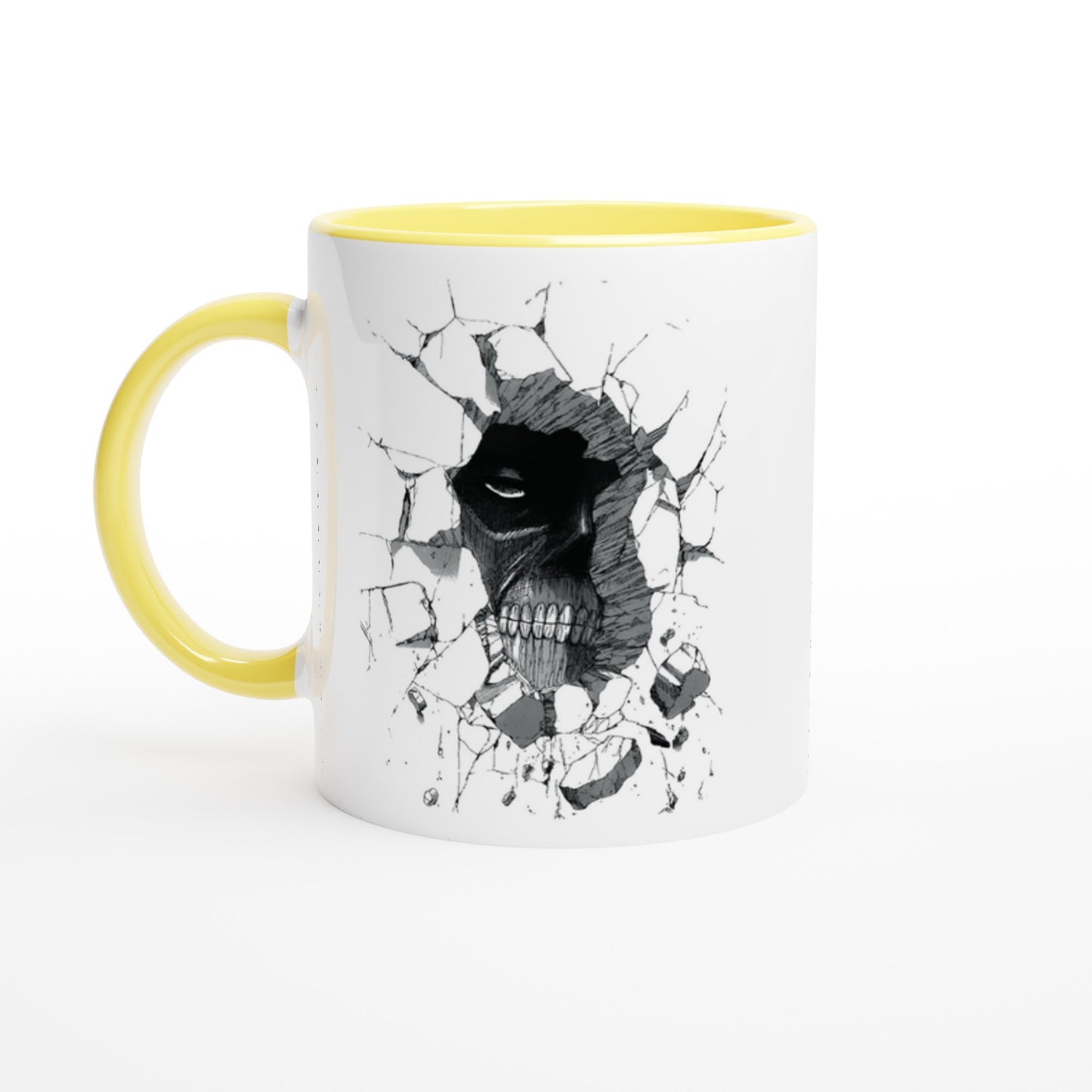 A white ceramic mug with a yellow handle and rim features an illustration of the Colossal Titan from Attack on Titan appearing to break through a wall.