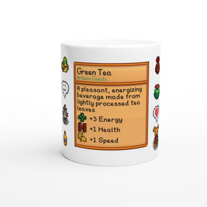 A white mug displays a Stardew Drinks pattern featuring a green tea beverage card with pixel art sprites and stats for energy, health, and speed.