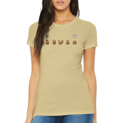 A woman wearing a tan Stardew Valley T-Shirt displays a graphic of ginger cats and emotes across the chest.