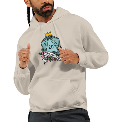 A man wearing a light-colored D&D hoodie displays a graphic of a D20 die with floral accents and the phrase "That's How I Roll" printed on it.