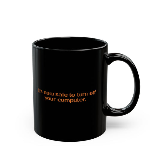 Black mug with orange text 'It's now safe to turn off your computer' on a white background - Windows 95 / 98 inspired