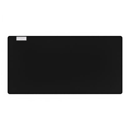 A black extra large desk mat features a small white label in the upper left corner.