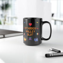 A black mug featuring pixel art graphics and the text Stardew Valley Slut in a colorful font.