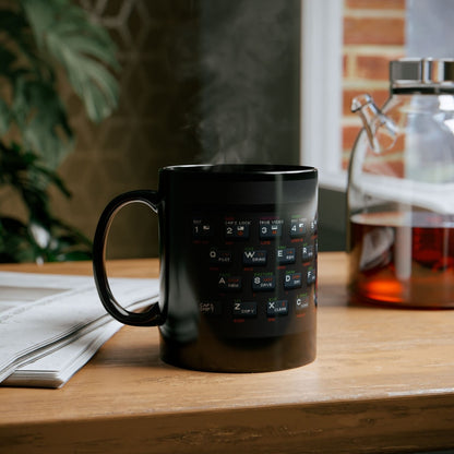 A black mug displays pixel art graphics resembling a Retro Spectrum keyboard layout.