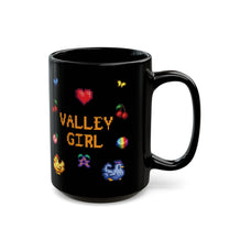A black coffee mug displays pixel art sprites / graphics from Stardew Valley including a heart, cherries, a prismatic shard, a stardrop, and butterflies.
