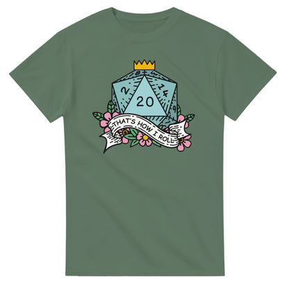 A dark green t-shirt displays a D20 die decorated with flowers and a banner reading "That's How I Roll," referencing the tabletop game Dungeons & Dragons.