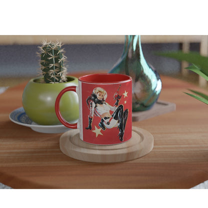 A white mug with a red handle displays a vintage distressed poster design featuring a pin-up girl advertising Nuka Cola from Fallout.