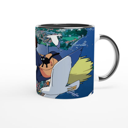 The mug depicts Kiki from Kiki's Delivery Service flying over Koriko on Gigi, a white bird, as illustrated in a Studio Ghibli style.