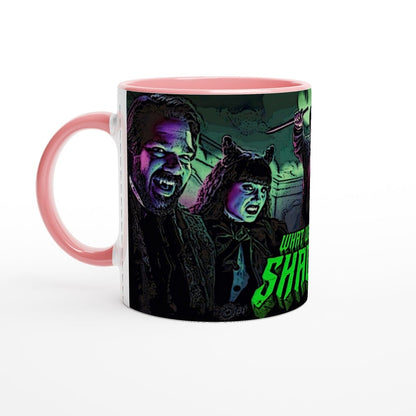 A ceramic mug displays an illustration of Laszlo and Nadja from What We Do In The Shadows, along with a partial view of the words "What" and "Shadows".