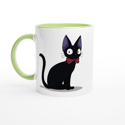 A white mug features a cartoon illustration of Gigi the Cat from Kiki's Delivery Service, wearing a red bow tie and set against a green interior rim and handle.