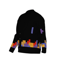 A black knitted cardigan featuring a colorful Tetromino game pattern of falling blocks across the bottom and sleeves.