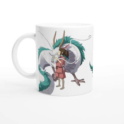 A white mug displays an illustration of Haku as a dragon embracing Chihiro, inspired by Studio Ghibli's Spirited Away.