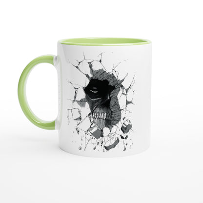 A white ceramic mug with a green handle and rim features an illustration of the Colossal Titan from Attack on Titan breaking through a wall.