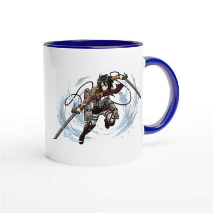 A white ceramic mug features an illustration of Mikasa Ackerman from Attack on Titan wielding her blades in a dynamic pose against a blue-rimmed background.