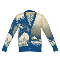 A long-sleeved knit cardigan featuring a blue and white Japanese art inspired Great Wave pattern on a cream background.