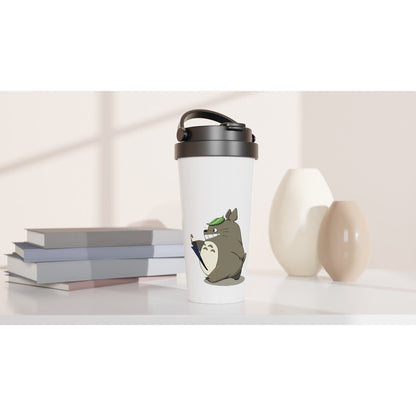 A white insulated travel mug featuring Totoro from Studio Ghibli sits on a shelf next to books and a vase.