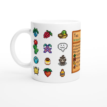 A white mug displays a colourful pattern of pixelated sprites and a beverage card referencing Stardew Drinks and tea.