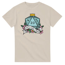 A beige t-shirt displays a D20 die surrounded by flowers and a banner reading "That's How I Roll," referencing the tabletop game Dungeons & Dragons.